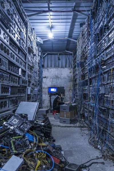 An aerial view of a bustling mining farm, showcasing rows of powerful rigs and advanced cooling systems